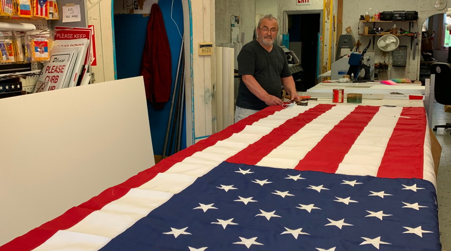 Flags being sewn by hand