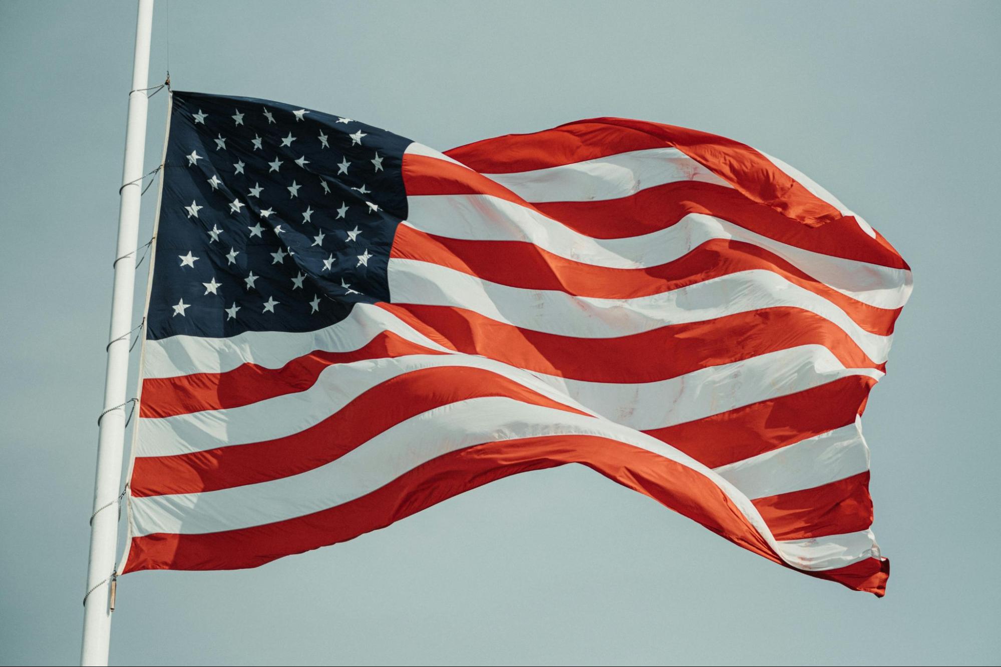 American flag with 50 stars waving against the sky